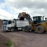 Backhoe Unloading on Delivery Truck — Earthmoving Repair in Koumala, QLD