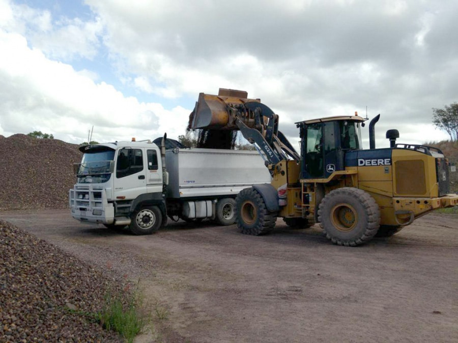 Backhoe Unloading on Delivery Truck — Earthmoving Repair in Koumala, QLD